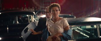 Movie still from “Saving Mr. Banks” (2013), directed by John Lee Hancock – An older woman in a white dress and a man in a black suit; Medium shot, Over the shoulder angle