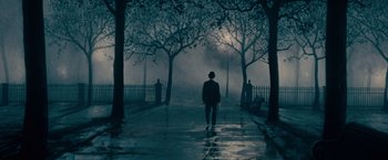 A man walking down a street at night