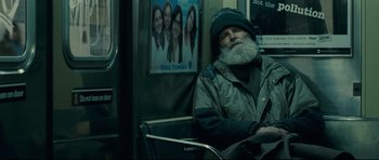 Movie still from “Shame” (2011), directed by Steve McQueen – An old man sitting on a bus with a long beard; Wide shot, Low angle