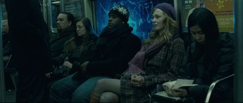 Movie still from “Shame” (2011), directed by Steve McQueen – A group of people sitting on a train; Medium shot, Over the shoulder angle
