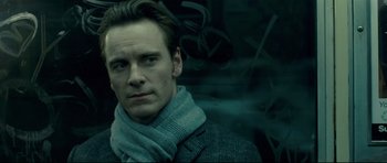 Movie still from “Shame” (2011), directed by Steve McQueen – A person wearing a jacket and a scarf; Close Up shot, Over the shoulder angle