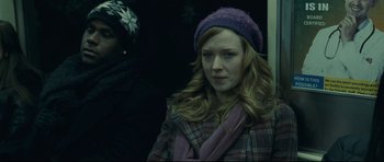 Movie still from “Shame” (2011), directed by Steve McQueen – A woman in a purple hat is standing in a bus; Close Up shot, Over the shoulder angle