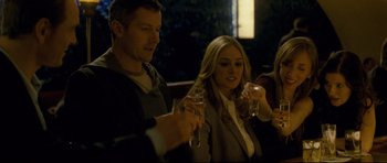 Movie still from “Shame” (2011), directed by Steve McQueen – A man and a woman holding glasses of wine; Medium shot, Over the shoulder angle