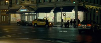 Movie still from “Shame” (2011), directed by Steve McQueen – A yellow taxi cab driving down a street; Wide shot, Over the shoulder angle