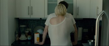 Movie still from “Shame” (2011), directed by Steve McQueen – A man and a woman in the kitchen; Medium shot, Over the shoulder angle