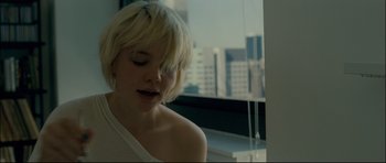 Movie still from “Shame” (2011), directed by Steve McQueen – A woman with short blonde hair looking out of a window; Close Up shot, Over the shoulder angle