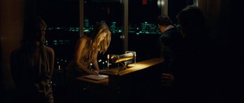 Movie still from “Shame” (2011), directed by Steve McQueen – A man and a woman standing in front of a desk; Medium shot, Over the shoulder angle
