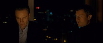 Movie still from “Shame” (2011), directed by Steve McQueen – A man standing in front of a window at night; Close Up shot, Over the shoulder angle