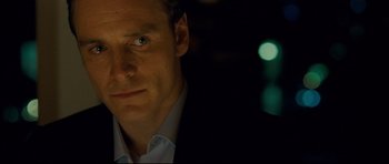 Movie still from “Shame” (2011), directed by Steve McQueen – A person wearing a suit and tie; Close Up shot, Over the shoulder angle