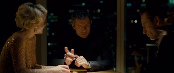 Movie still from “Shame” (2011), directed by Steve McQueen – A man sitting in front of a window at a table; Medium shot, Over the shoulder angle