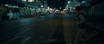 Movie still from “Shame” (2011), directed by Steve McQueen – A city street at night lit up by streetlights; Extreme Wide shot, High angle