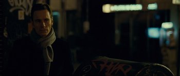 Movie still from “Shame” (2011), directed by Steve McQueen – A man sitting on a chair in a dark room; Close Up shot, Over the shoulder angle