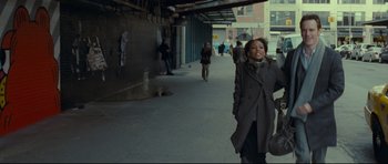 Movie still from “Shame” (2011), directed by Steve McQueen – A woman is walking down the sidewalk in a city; Wide shot, Low angle