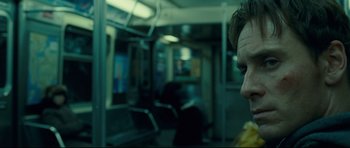Movie still from “Shame” (2011), directed by Steve McQueen – A man sitting on a train looking out of the window; Close Up shot, Over the shoulder angle
