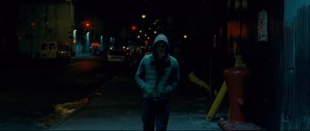 Movie still from “Shame” (2011), directed by Steve McQueen – A man is standing on the sidewalk at night; Wide shot, Low angle