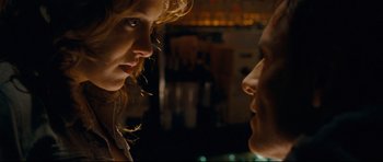 Movie still from “Shame” (2011), directed by Steve McQueen – A woman and a man face to face in a dark room; Close Up shot, Over the shoulder angle