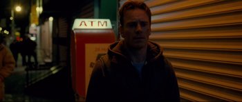 Movie still from “Shame” (2011), directed by Steve McQueen – A man standing in front of an atm machine; Close Up shot, Low angle