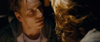 Movie still from “Shame” (2011), directed by Steve McQueen – A person looking at another person; Close Up shot, Over the shoulder angle