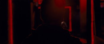 Movie still from “Shame” (2011), directed by Steve McQueen – A man sitting in front of a tv in a dark room; Close Up shot, Low angle