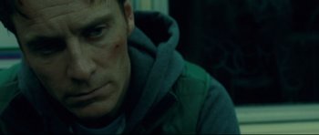 Movie still from “Shame” (2011), directed by Steve McQueen – A person wearing a hooded jacket; Close Up shot, Low angle