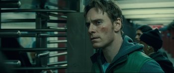 Movie still from “Shame” (2011), directed by Steve McQueen – A person in a room; Close Up shot, Over the shoulder angle