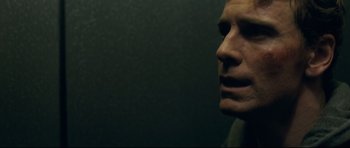 Movie still from “Shame” (2011), directed by Steve McQueen – A man's face in a dark room; Close Up shot, Low angle