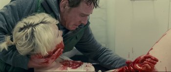 Movie still from “Shame” (2011), directed by Steve McQueen – A man is holding a knife and a woman's face; Close Up shot, Over the shoulder angle