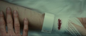 Movie still from “Shame” (2011), directed by Steve McQueen – A person's arm with a bandage on it; Extreme Close Up shot, High angle