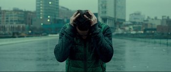 Movie still from “Shame” (2011), directed by Steve McQueen – A man with his hands on his head in the middle of a street; Close Up shot, Over the shoulder angle