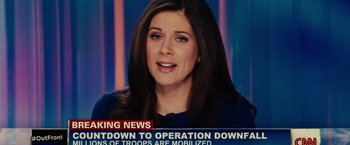 Movie still from “Edge of Tomorrow” (2014), directed by Doug Liman – A woman is talking on a news channel; Close Up shot, Over the shoulder angle