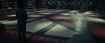 Movie still from “Edge of Tomorrow” (2014), directed by Doug Liman – The floor of an industrial building has a cross on it; Extreme Wide shot, High angle