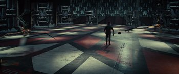 Movie still from “Edge of Tomorrow” (2014), directed by Doug Liman – A man standing in an empty room holding a skateboard; Extreme Wide shot, High angle