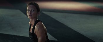Movie still from “Edge of Tomorrow” (2014), directed by Doug Liman – A woman is standing in the street at night; Close Up shot, Low angle