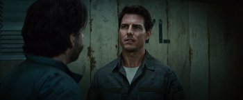 Movie still from “Edge of Tomorrow” (2014), directed by Doug Liman – A man in a green shirt is talking to another man; Close Up shot, Over the shoulder angle