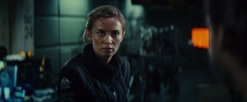 Movie still from “Edge of Tomorrow” (2014), directed by Doug Liman – A person wearing a jacket; Close Up shot, Over the shoulder angle