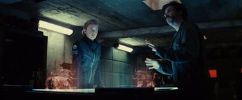 Movie still from “Edge of Tomorrow” (2014), directed by Doug Liman – A man and a woman are talking to each other in a room; Medium shot, Over the shoulder angle