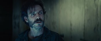 Movie still from “Edge of Tomorrow” (2014), directed by Doug Liman – A person with long hair and a beard; Close Up shot, Low angle