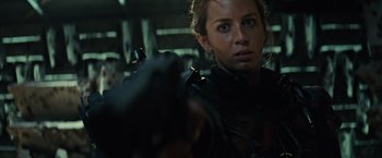 Movie still from “Edge of Tomorrow” (2014), directed by Doug Liman – A person holding a gun in a room; Close Up shot, Low angle