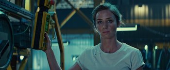 Movie still from “Edge of Tomorrow” (2014), directed by Doug Liman – A person holding a water hose; Close Up shot, Low angle