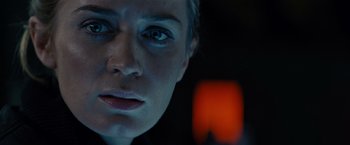 Movie still from “Edge of Tomorrow” (2014), directed by Doug Liman – A woman's face in front of an orange light; Close Up shot, Over the shoulder angle