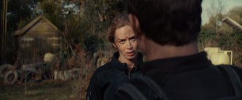 Movie still from “Edge of Tomorrow” (2014), directed by Doug Liman – A woman in black jacket talking to a man in black jacket; Close Up shot, Over the shoulder angle