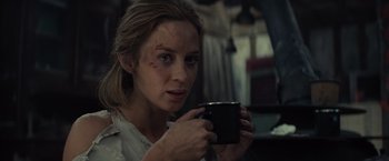 Movie still from “Edge of Tomorrow” (2014), directed by Doug Liman – A woman holding a black mug in her hands; Close Up shot, Over the shoulder angle