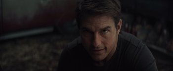 Movie still from “Edge of Tomorrow” (2014), directed by Doug Liman – A person wearing a black t - shirt; Close Up shot, Over the shoulder angle