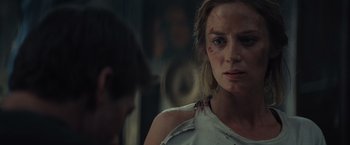 Movie still from “Edge of Tomorrow” (2014), directed by Doug Liman – A woman with a knife in her mouth and blood on her face; Close Up shot, Over the shoulder angle