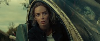Movie still from “Edge of Tomorrow” (2014), directed by Doug Liman – A woman sitting in the back of a car looking out the window; Close Up shot, Over the shoulder angle