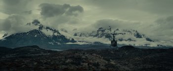 Movie still from “Edge of Tomorrow” (2014), directed by Doug Liman – A helicopter is flying over a mountain range; Extreme Wide shot, High angle