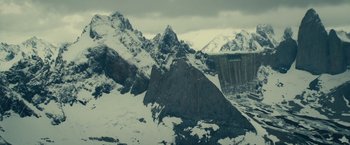 Movie still from “Edge of Tomorrow” (2014), directed by Doug Liman – A view of a mountain range with snow on it's slopes; Extreme Wide shot, High angle