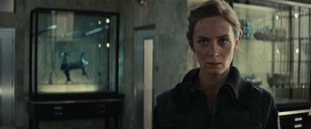 Movie still from “Edge of Tomorrow” (2014), directed by Doug Liman – A person in a room; Close Up shot, Over the shoulder angle