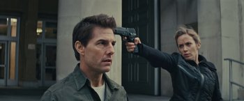 Movie still from “Edge of Tomorrow” (2014), directed by Doug Liman – A man getting his hair cut by a man with a gun; Close Up shot, Over the shoulder angle