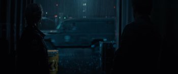 Movie still from “Edge of Tomorrow” (2014), directed by Doug Liman – A blurry picture of a van in the rain; Medium shot, Over the shoulder angle